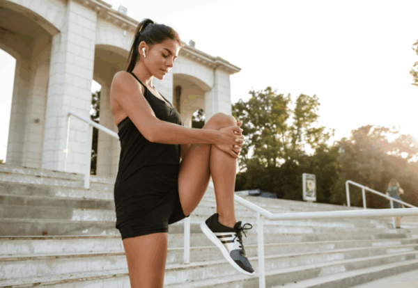 portrait-fitness-woman-earphones-stretching-her-legs (1) (1)